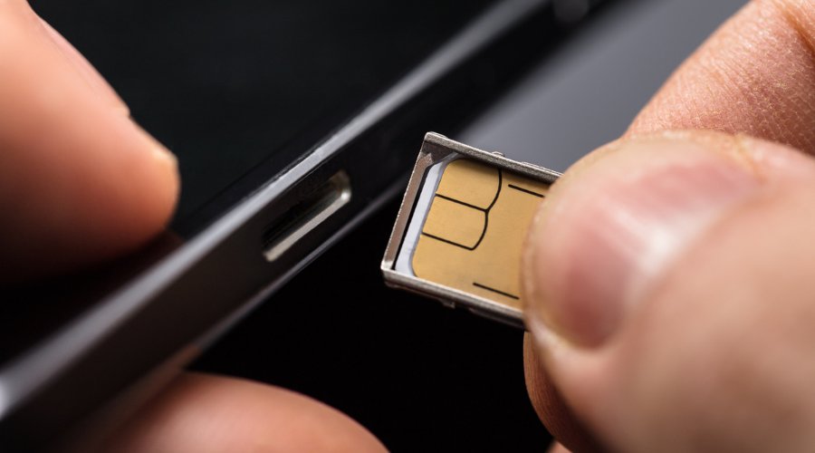 sim card being inserted into a mobile phone